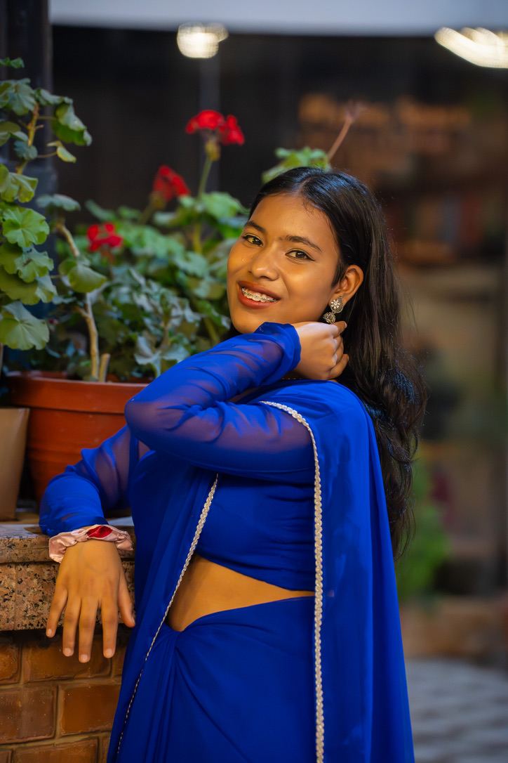 Bandana in a blue sari, smiling
