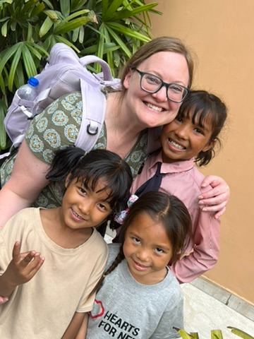 A Hearts for Nepal Legacy Partner with three girls in Nepal