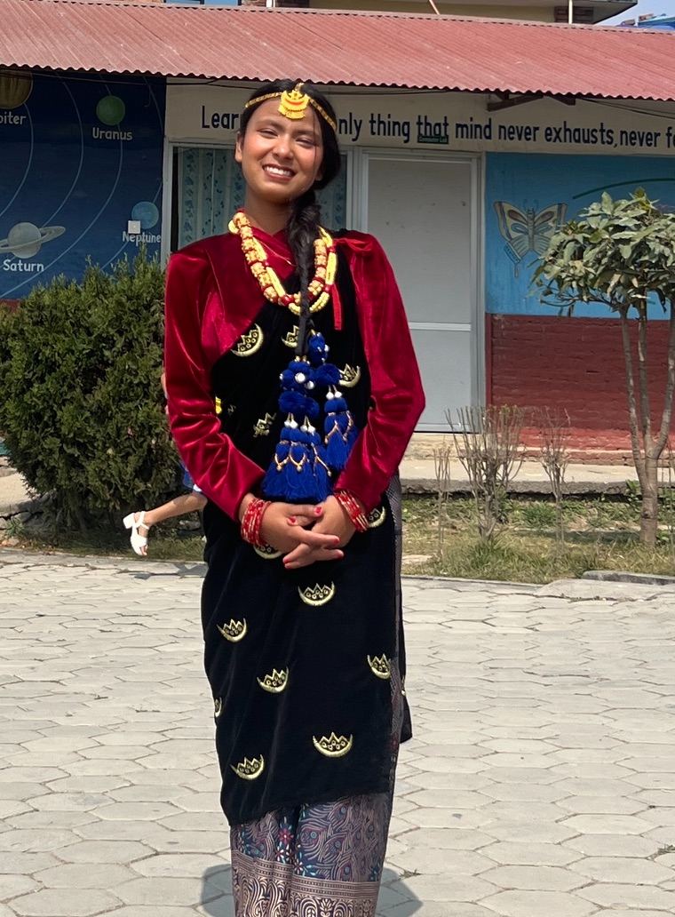 One of the girls in traditional Nepali dress at school, in her new life with Hearts for Nepal